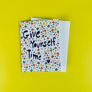 Greeting card with 'Give Yourself Time' text on a yellow background