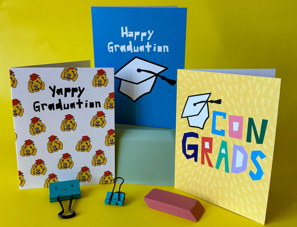 Three graduation-themed greeting cards on a yellow background
